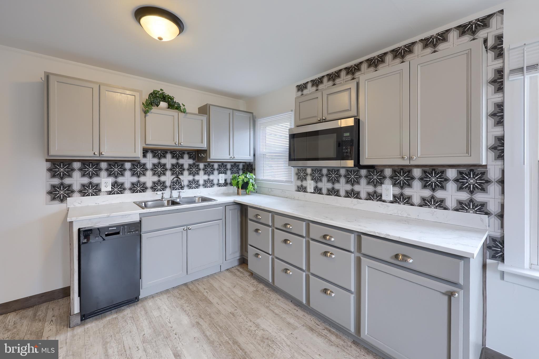 1802 Filbert Street York, PA 17404 - Photo 17 of 30 a kitchen with sink cabinets and window