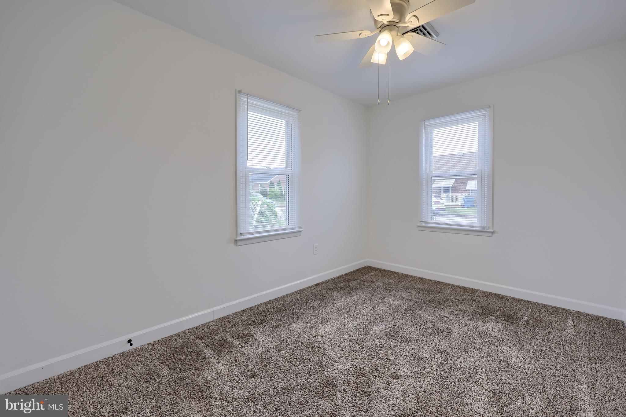 1802 Filbert Street York, PA 17404 - Photo 10 of 30 an empty room with a chandelier fan and windows