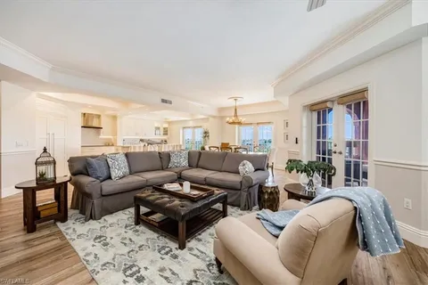 a living room with furniture wooden floor and a rug