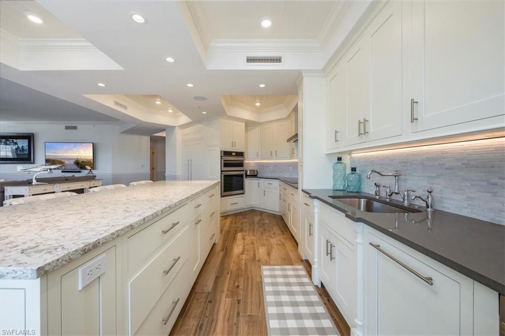 451 Bayfront Place, Unit 5407 Naples, FL 34102 - Photo 3 of 21 a large kitchen with stainless steel appliances kitchen island a large counter top and a sink