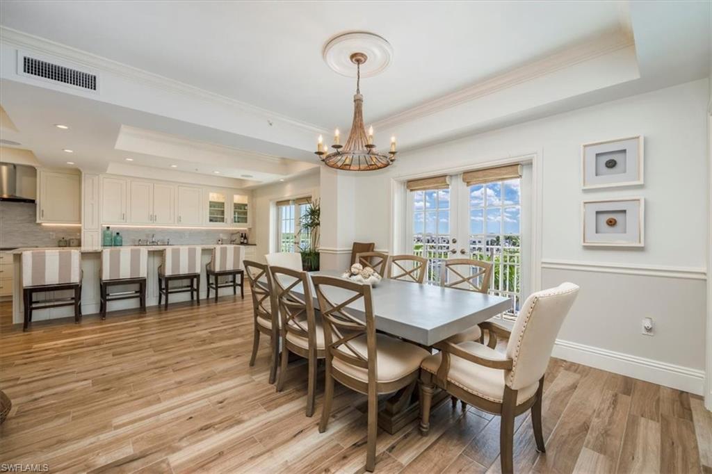 451 Bayfront Place, Unit 5407 Naples, FL 34102 - Photo 4 of 21 a view of a dining room with furniture and wooden floor