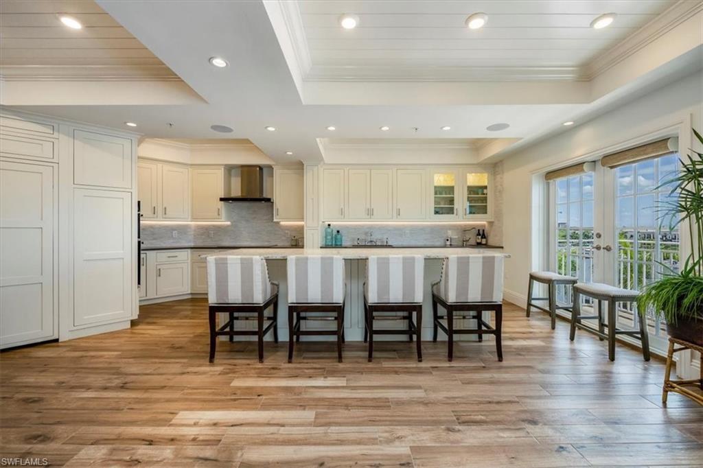 451 Bayfront Place, Unit 5407 Naples, FL 34102 - Photo 5 of 21 a kitchen with stainless steel appliances granite countertop a dining table chairs and granite counter tops
