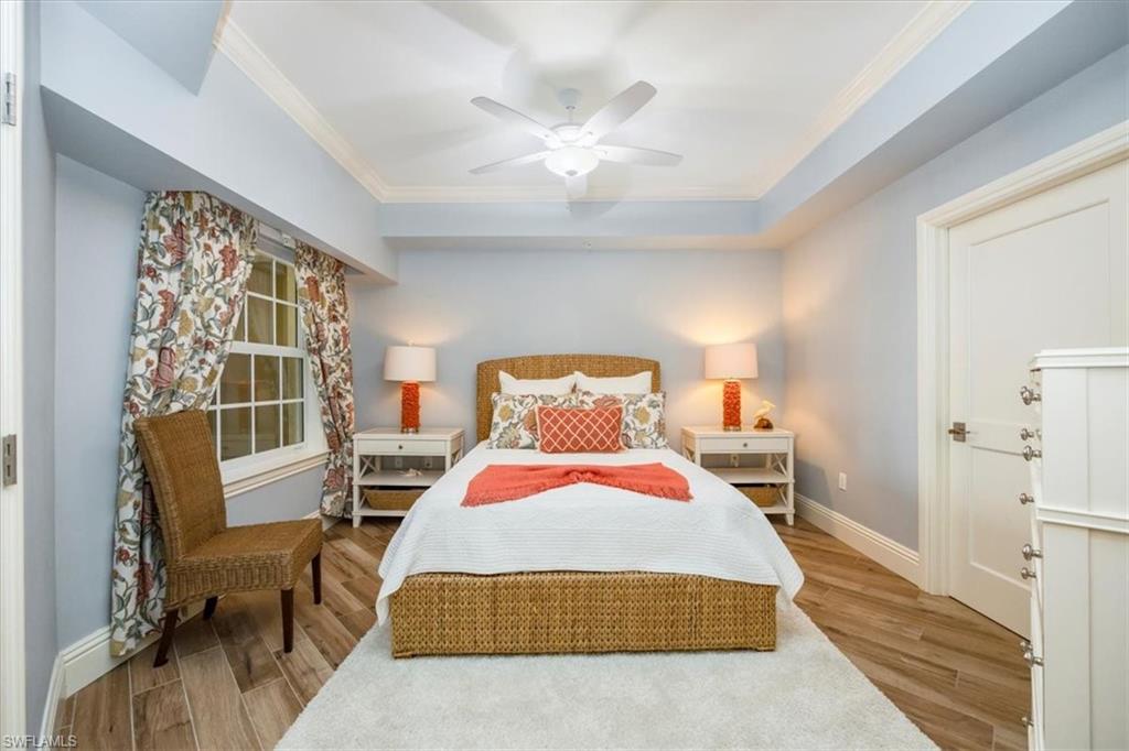 451 Bayfront Place, Unit 5407 Naples, FL 34102 - Photo 10 of 21 a bedroom with a bed and wooden floor
