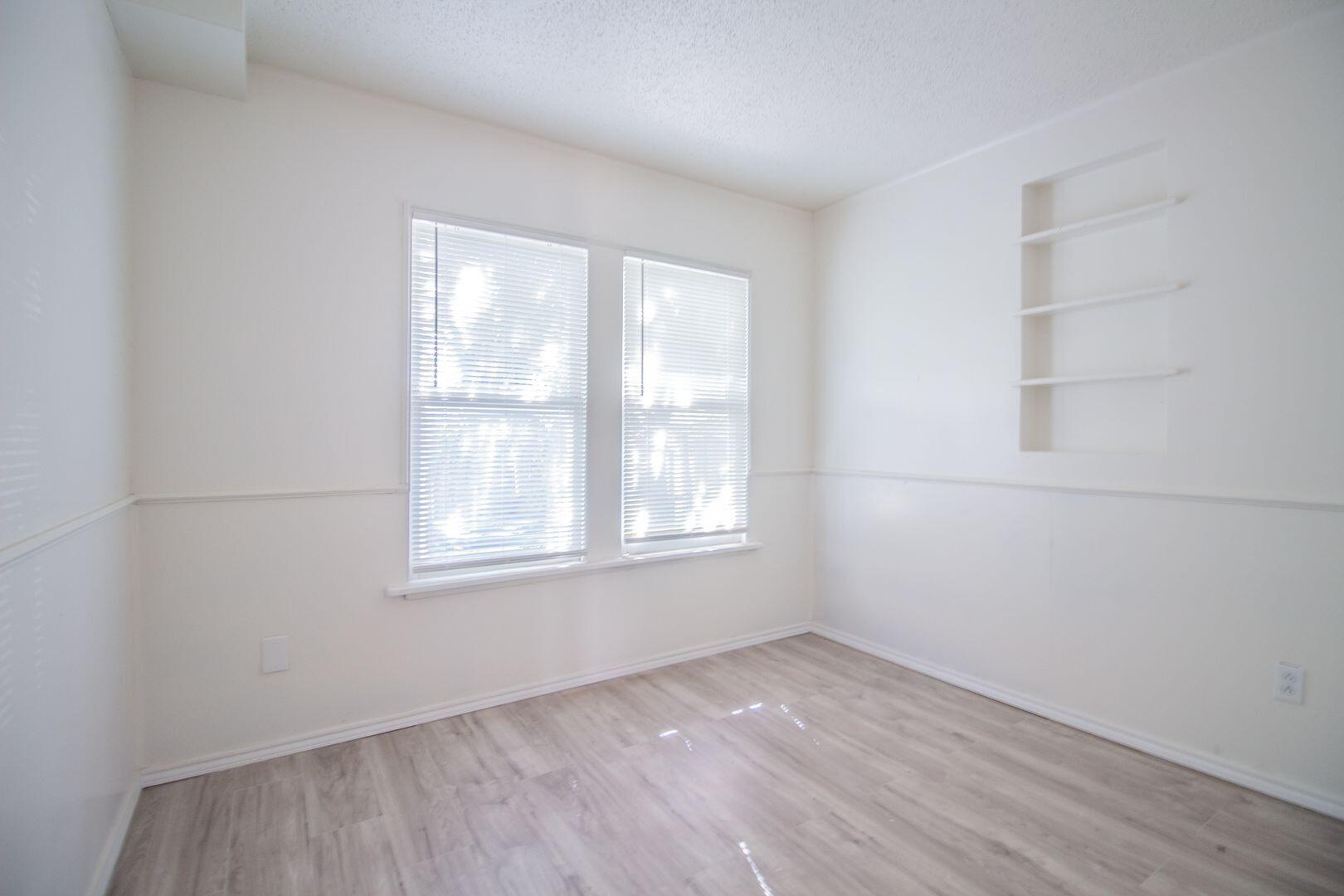 1918 20th Street Lubbock, TX 79411 - Photo 11 of 13 an empty room with a window