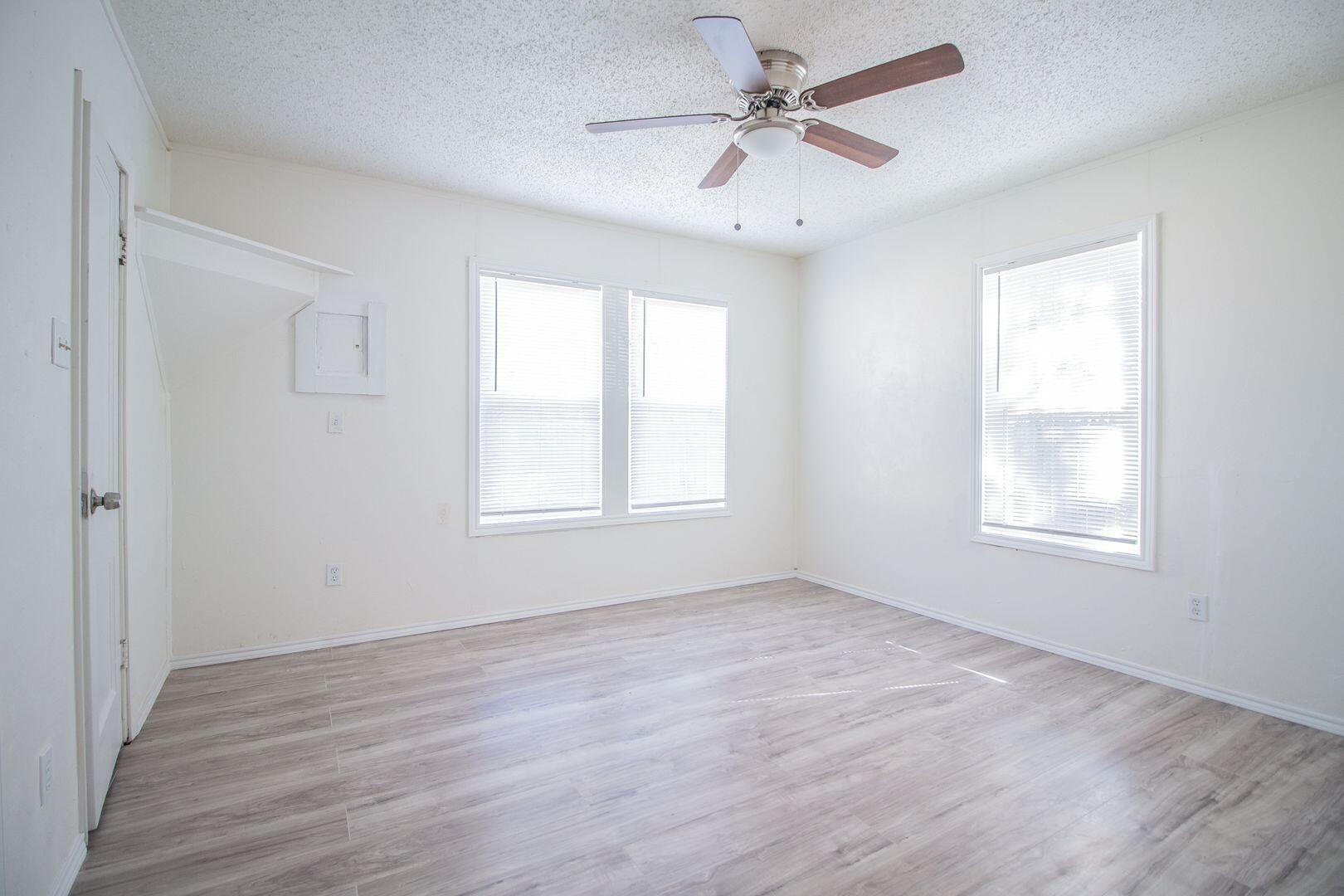 1918 20th Street Lubbock, TX 79411 - Photo 12 of 13 a view of an empty room with a window and wooden floor