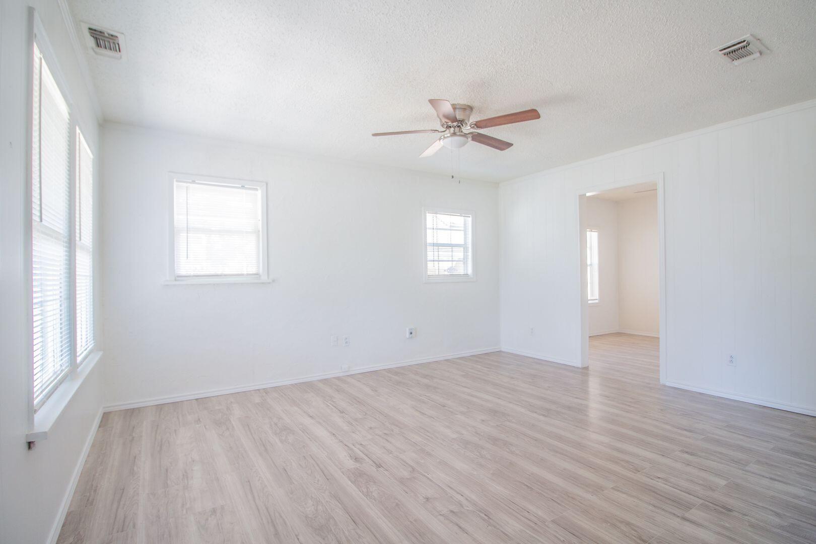 1918 20th Street Lubbock, TX 79411 - Photo 9 of 13 a view of empty room with wooden floor and fan