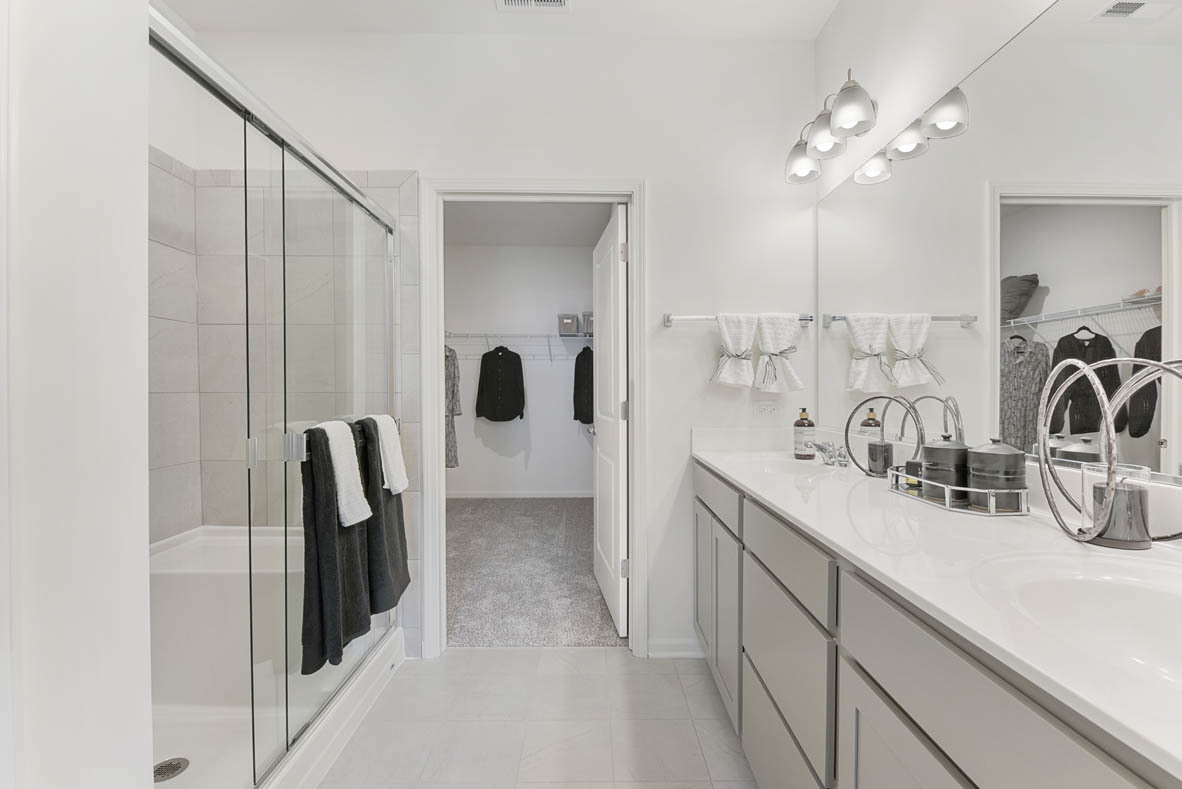 303 Ridley Street North Aurora, IL 60542 - Photo 12 of 36 a spacious bathroom with a double vanity sink a mirror and shower
