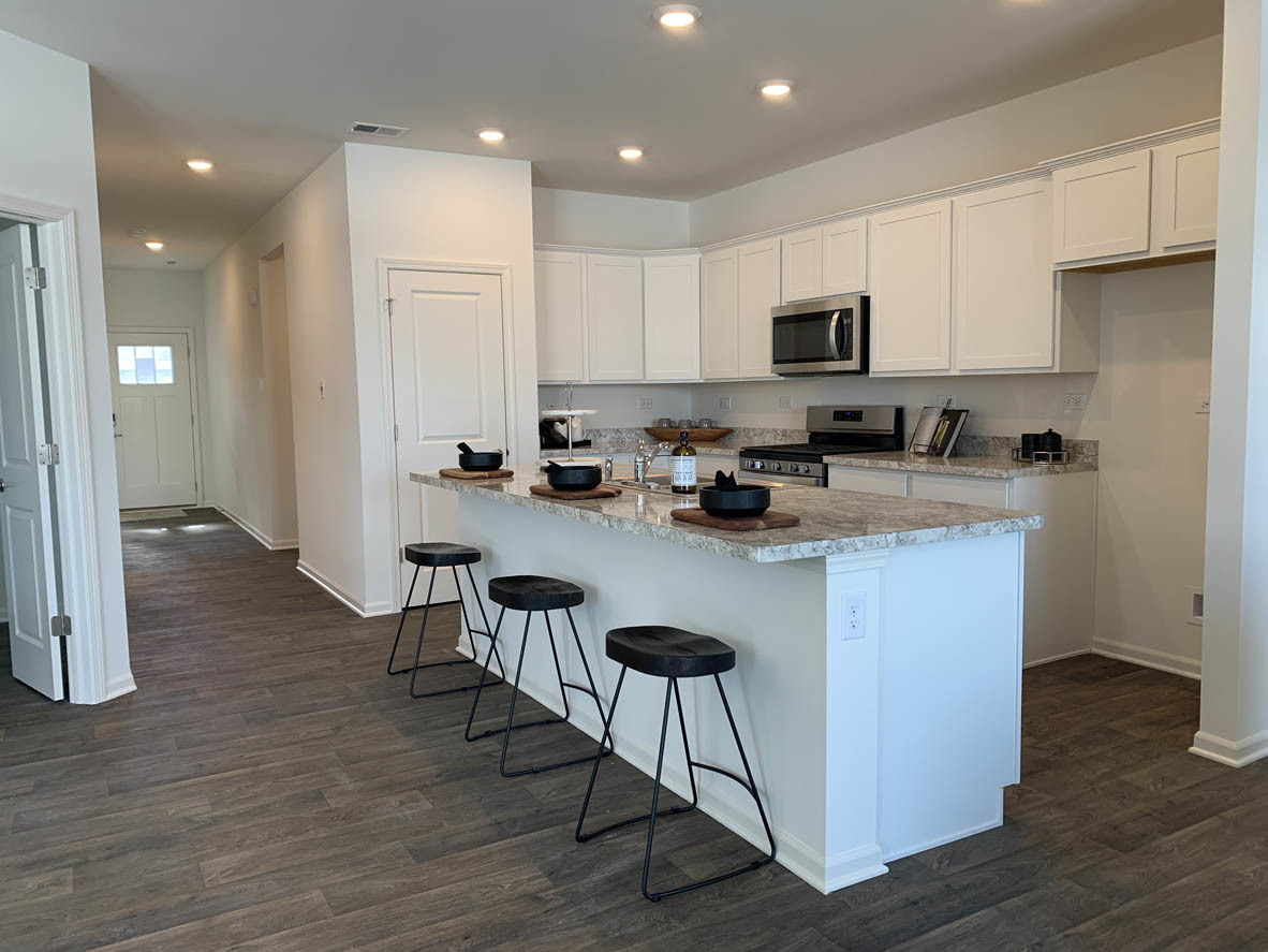 303 Ridley Street North Aurora, IL 60542 - Photo 2 of 36 a kitchen with stainless steel appliances granite countertop a stove a sink a refrigerator and a microwave