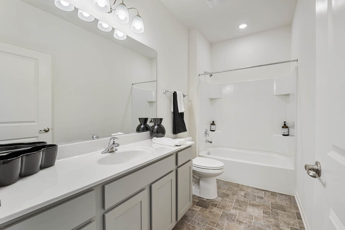 303 Ridley Street North Aurora, IL 60542 - Photo 8 of 36 a bathroom with a sink a toilet a mirror and shower