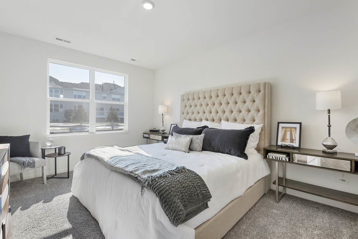 303 Ridley Street North Aurora, IL 60542 - Photo 9 of 36 a bedroom with a large bed and a table