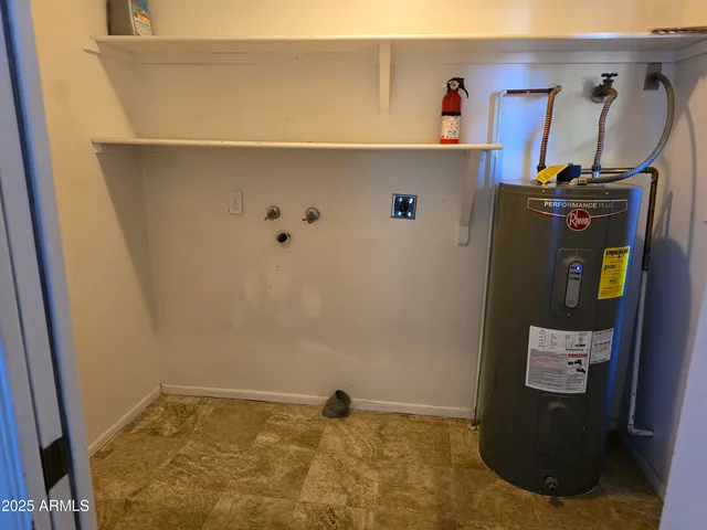 a view of storage and utility room with closet