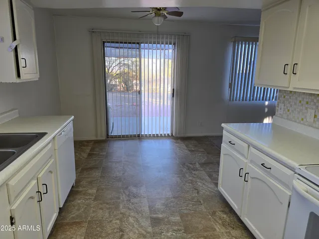 a view of a kitchen with cabinets and wooden floor