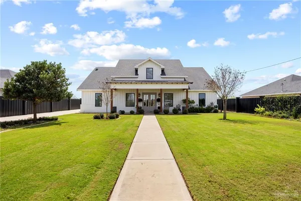 a view of house with swimming pool and view of a lake