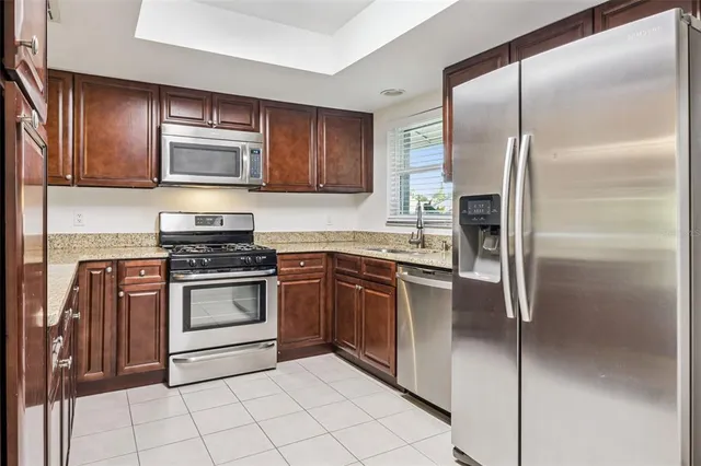 a kitchen with granite countertop sink and cabinets