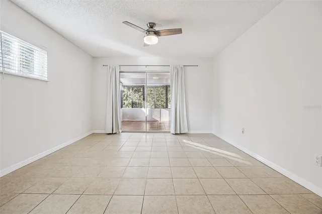 a view of empty room with ceiling fan