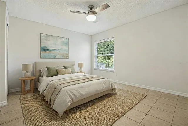 an empty room with windows and fan