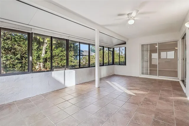 a large white kitchen with a large window