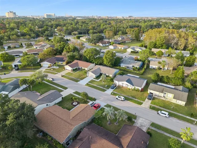 an aerial view of multiple houses with a yard