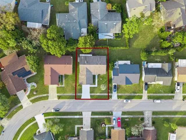 a view of swimming pool with seating area and trees in the background
