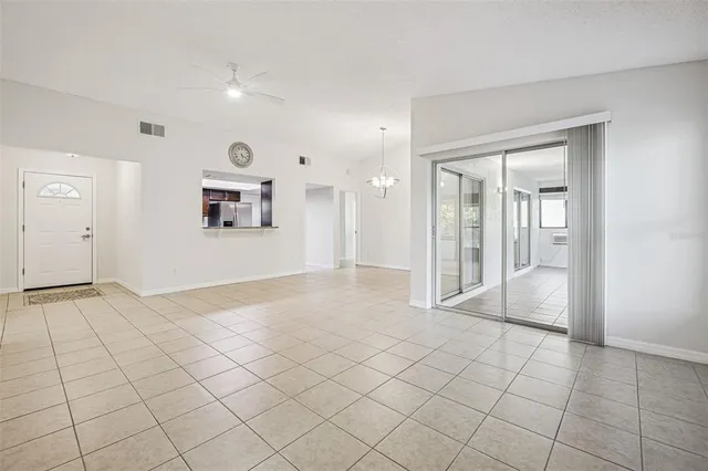 a living room with furniture potted plant and a view of kitchen