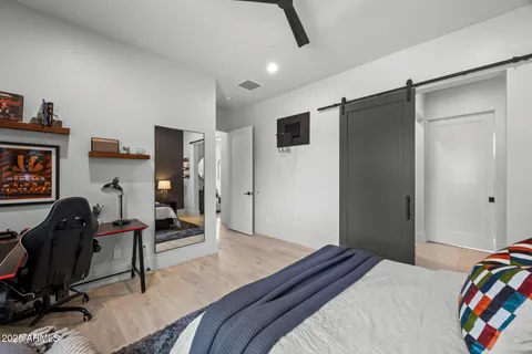 a living room with furniture a flat screen tv and kitchen view