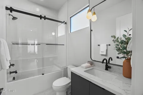 a kitchen with a table chairs stove and living room view