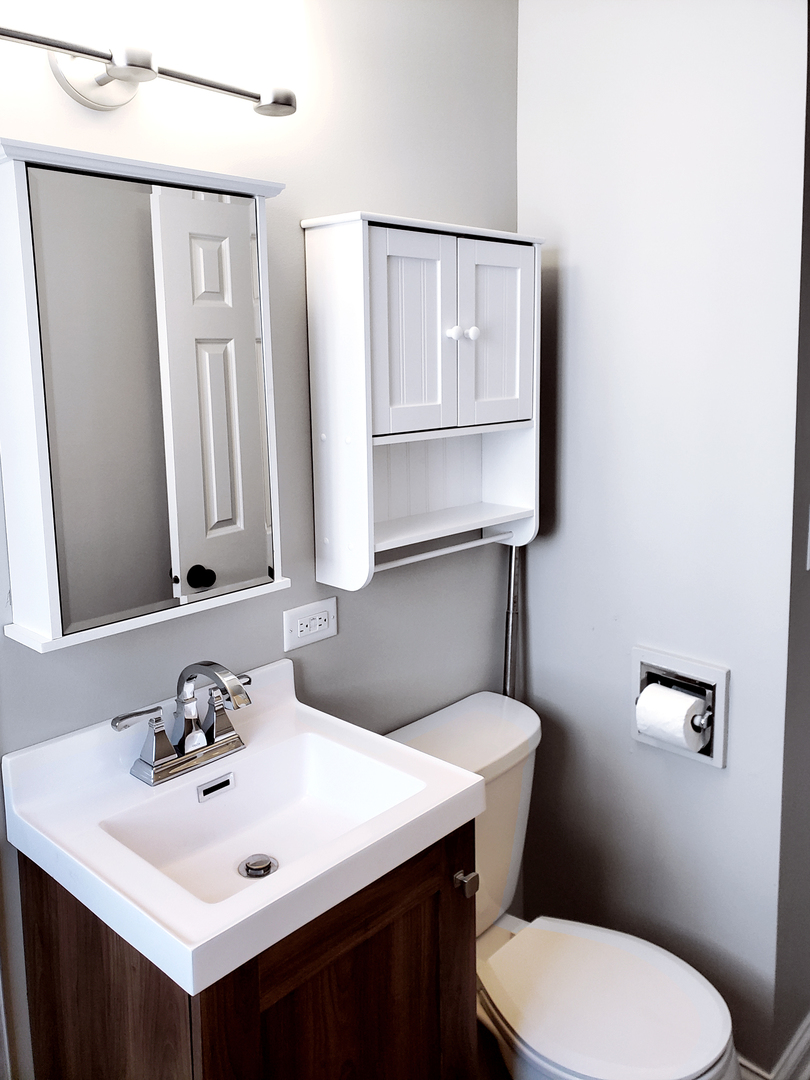 18244 Stewart Avenue Homewood, IL 60430 - Photo 13 of 16 a bathroom with a sink a toilet and mirror