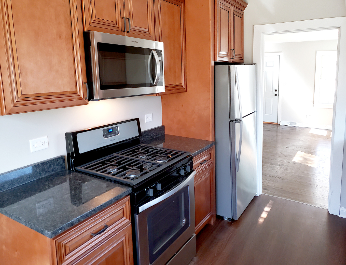 18244 Stewart Avenue Homewood, IL 60430 - Photo 2 of 16 a kitchen with stainless steel appliances granite countertop a stove a refrigerator and a microwave