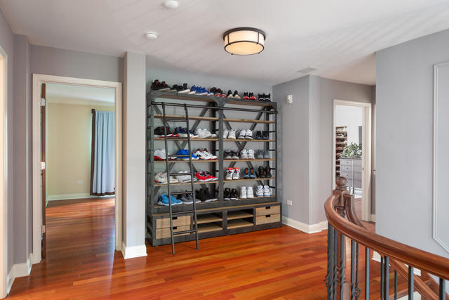 1731 Elyse Lane Naperville, IL 60565 - Photo 16 of 34 a room with lots of books and a wooden floor
