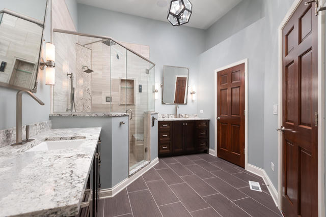 1731 Elyse Lane Naperville, IL 60565 - Photo 18 of 34 a large bathroom with a granite countertop double vanity sink a mirror a bathtub and shower