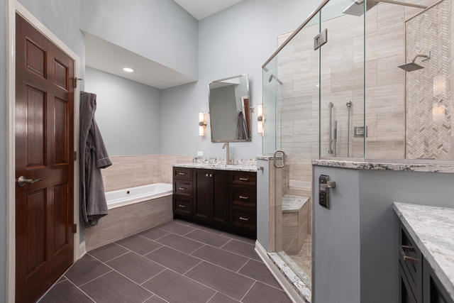 1731 Elyse Lane Naperville, IL 60565 - Photo 19 of 34 a bathroom with a double vanity sink and mirror with bathtub