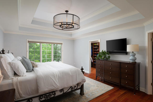 1731 Elyse Lane Naperville, IL 60565 - Photo 20 of 34 a bedroom with a bed and a flat tv screen on dresser