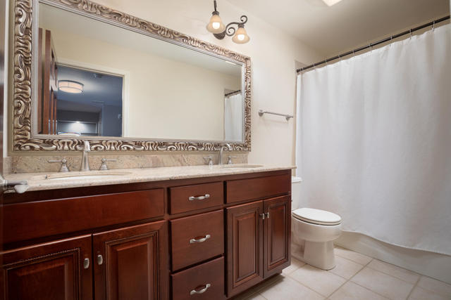 1731 Elyse Lane Naperville, IL 60565 - Photo 23 of 34 a bathroom with a sink and a mirror