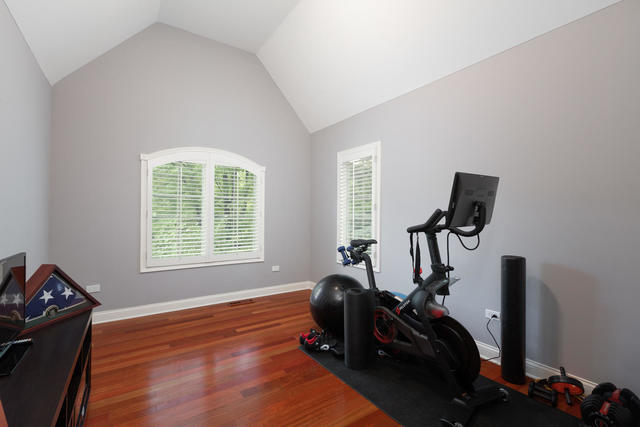 1731 Elyse Lane Naperville, IL 60565 - Photo 24 of 34 a room with gym equipment and wooden floor