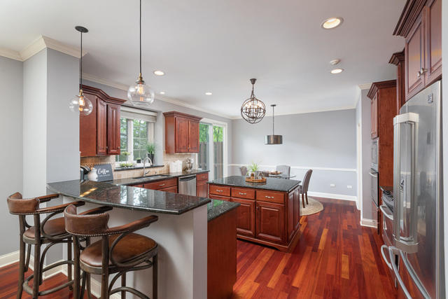1731 Elyse Lane Naperville, IL 60565 - Photo 9 of 34 a view of a dining room with furniture window and wooden floor