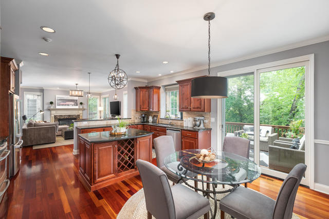 1731 Elyse Lane Naperville, IL 60565 - Photo 10 of 34 a dining room with furniture a chandelier and wooden floor