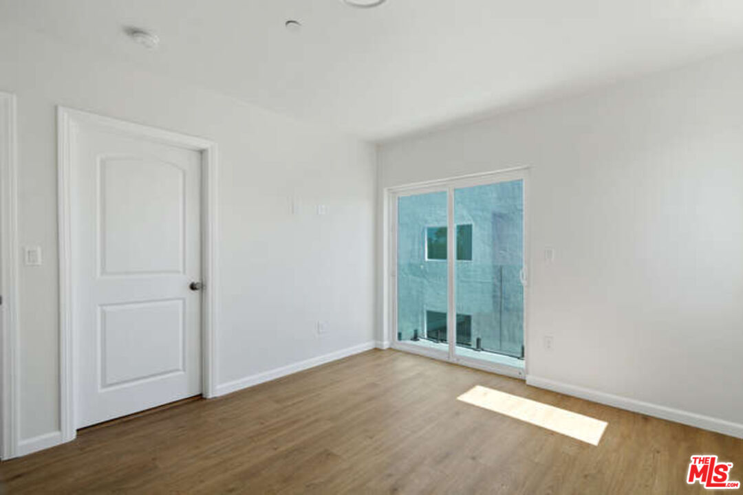 2636 Virginia Road Los Angeles, CA 90016 - Photo 16 of 31 a view of an empty room with wooden floor and a window