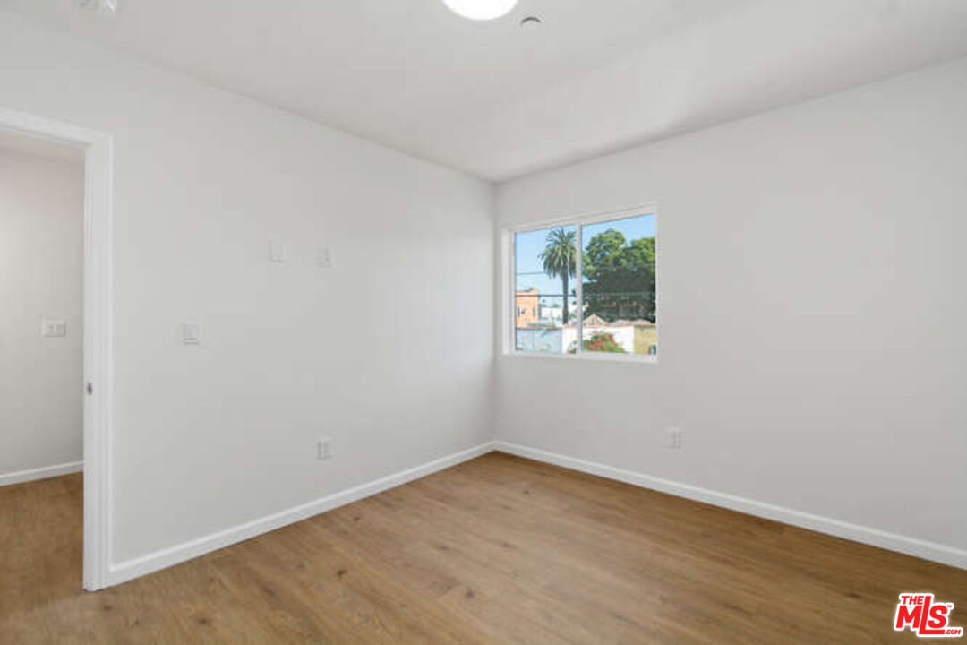 2636 Virginia Road Los Angeles, CA 90016 - Photo 18 of 31 an empty room with wooden floor and window