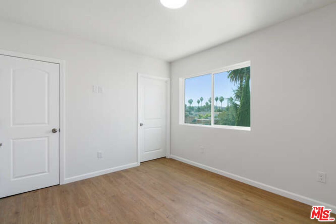 2636 Virginia Road Los Angeles, CA 90016 - Photo 19 of 31 a view of an empty room with wooden floor and a window