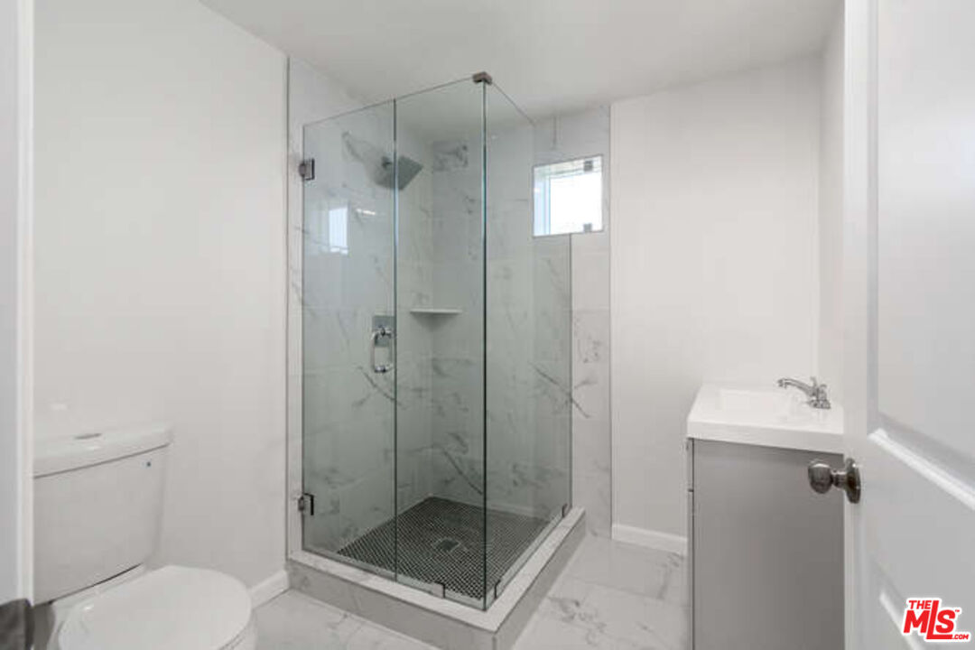 2636 Virginia Road Los Angeles, CA 90016 - Photo 20 of 31 a bathroom with a shower a toilet and a sink