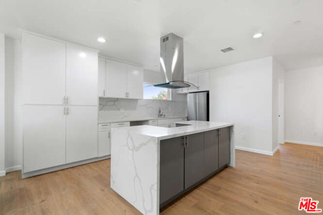 2636 Virginia Road Los Angeles, CA 90016 - Photo 22 of 31 a kitchen with a sink a stove cabinets and wooden floor