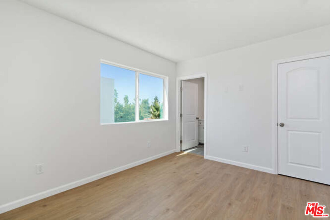 2636 Virginia Road Los Angeles, CA 90016 - Photo 25 of 31 a view of an empty room with wooden floor and a window