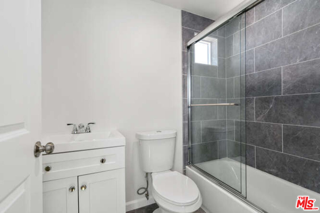 2636 Virginia Road Los Angeles, CA 90016 - Photo 26 of 31 a bathroom with a sink a toilet and shower