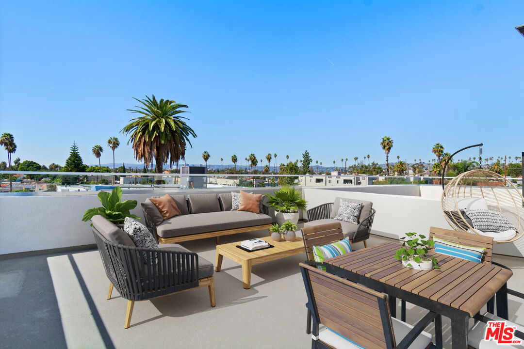 2636 Virginia Road Los Angeles, CA 90016 - Photo 4 of 31 a roof deck with couches and wooden floor