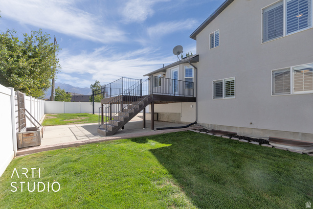 704 West Vahe Street Draper, UT 84020 - Photo 30 of 35 Expansive backyard featuring a manicured lawn, concrete patio, and white vinyl fencing