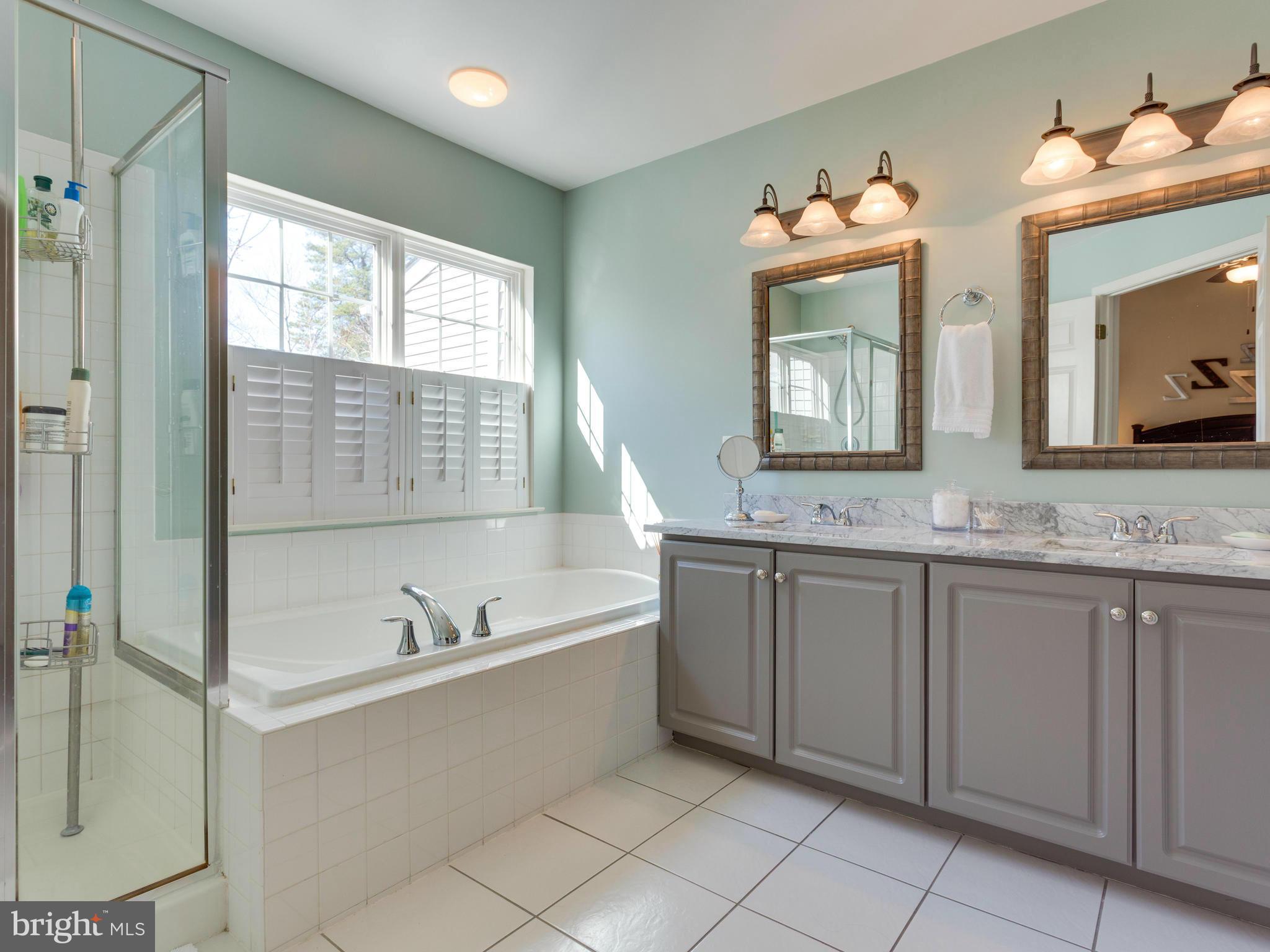 7310 Hampton Manor Place Springfield, VA 22150 - Photo 14 of 30 a spacious bathroom with a granite countertop sink mirror and bathtub