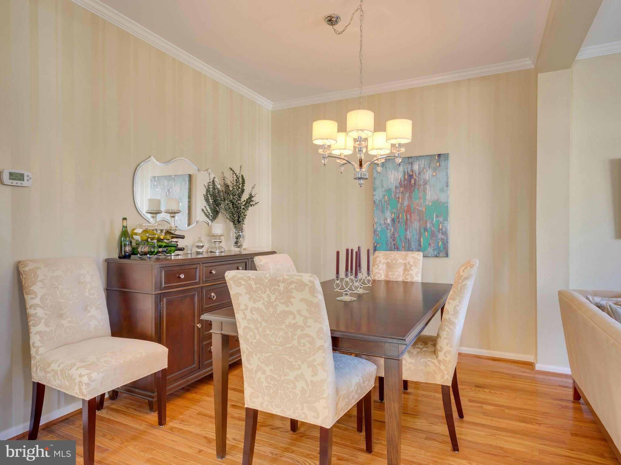 7310 Hampton Manor Place Springfield, VA 22150 - Photo 7 of 30 a dining room with furniture a chandelier and wooden floor