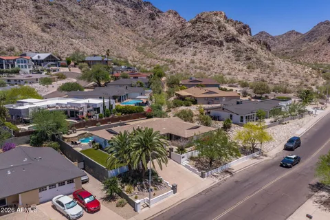 an aerial view of multiple houses with yard