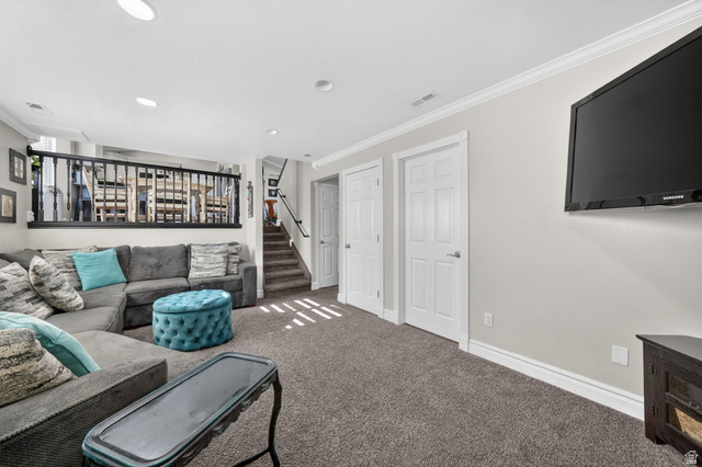 415 East 400 North Santaquin, UT 84655 - Photo 12 of 39 Spacious carpeted recreation room featuring recessed lighting, white crown molding, and a built-in wall-mounted television