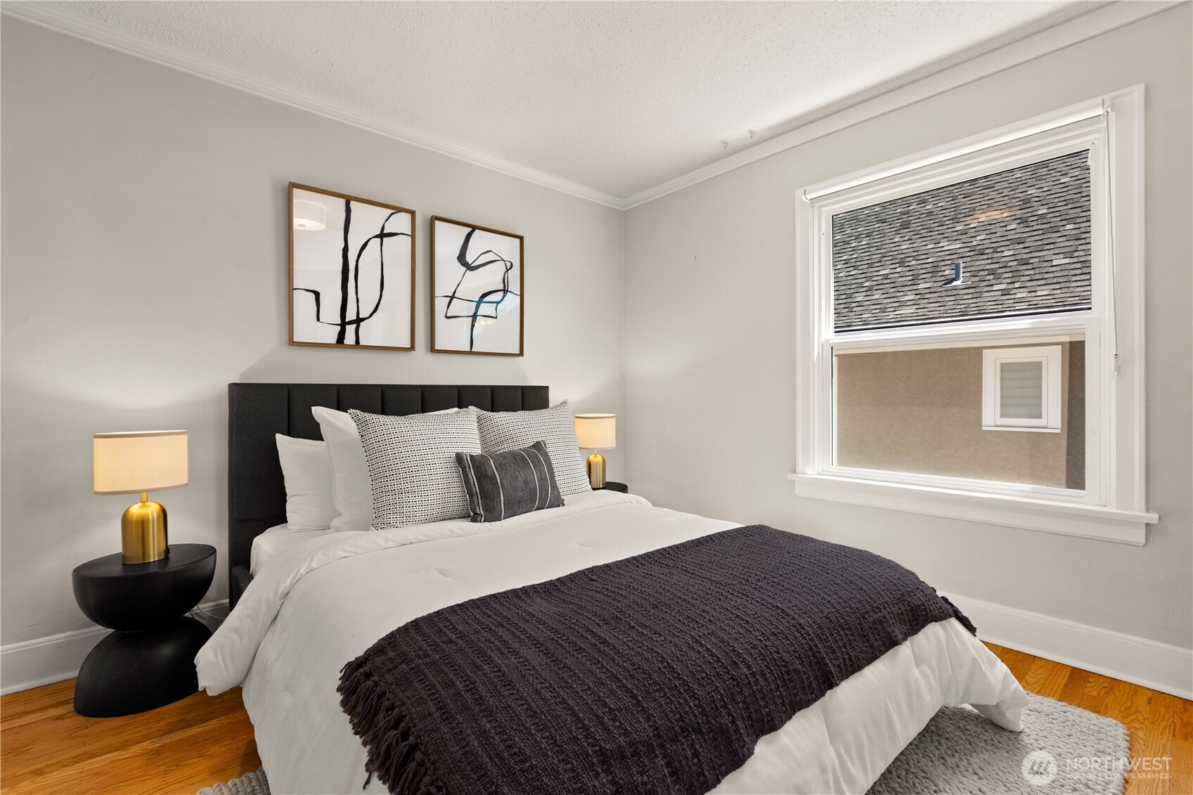 3617 East Cherry Street Seattle, WA 98122 - Photo 17 of 34 a bedroom with a bed and wooden floor